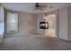 Neutral living room with a fireplace, neutral carpet and view to the Primary bathroom at 1534 Waterford Falls Ave, Las Vegas, NV 89123