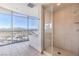 Bright bathroom features a glass-enclosed shower with a large window and city views at 200 W Sahara Ave # 2108, Las Vegas, NV 89102