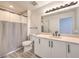 Bathroom features vanity with ample storage, mirror with lighting, and a shower with curtain at 200 W Sahara Ave # 2108, Las Vegas, NV 89102
