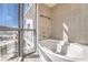 Modern bathroom features a soaking tub and a large window at 200 W Sahara Ave # 2108, Las Vegas, NV 89102