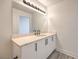 Modern bathroom features vanity with ample storage, mirror with lighting, and hardwood floors at 200 W Sahara Ave # 2108, Las Vegas, NV 89102