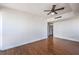 A sunlit bedroom showcases wood floors, white walls, and a modern ceiling fan at 200 W Sahara Ave # 2108, Las Vegas, NV 89102