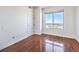 Bright bedroom has wood floors, a window with city views, and a white door at 200 W Sahara Ave # 2108, Las Vegas, NV 89102