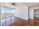 Bright bedroom featuring wood floors, a ceiling fan and a large window with a city view at 200 W Sahara Ave # 2108, Las Vegas, NV 89102