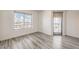 Well-lit bedroom with hardwood floors, a large window, and a balcony door offering stunning city views at 200 W Sahara Ave # 2108, Las Vegas, NV 89102