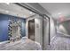 A modern elevator lobby features an elevator, a mirror with a mosaic frame, and blue accent walls at 200 W Sahara Ave # 2108, Las Vegas, NV 89102