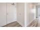 Hallway view featuring neutral walls, modern gray floors, and a secure front door with chrome hardware at 200 W Sahara Ave # 2108, Las Vegas, NV 89102
