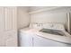 Convenient laundry room with washer and dryer and a shelf for storage at 200 W Sahara Ave # 2108, Las Vegas, NV 89102
