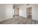 Spacious living room with hardwood floors, modern lighting, and access to a walk-in closet at 200 W Sahara Ave # 2108, Las Vegas, NV 89102