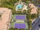 Overhead view of a community pool, tennis courts, and surrounding tropical landscaping at 260 E Flamingo Rd # 311, Las Vegas, NV 89169