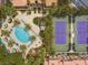 Overhead view of a community pool, tennis courts, and surrounding tropical landscaping at 260 E Flamingo Rd # 311, Las Vegas, NV 89169