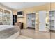 Cozy bedroom features closet with mirrored doors, shelving and a private balcony at 260 E Flamingo Rd # 311, Las Vegas, NV 89169