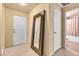 Hallway with tiled floors and doors to a bathroom and an exterior entrance, plus a large mirror at 260 E Flamingo Rd # 311, Las Vegas, NV 89169