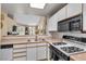 Bright kitchen with white cabinetry, a skylight, and stainless steel appliances at 260 E Flamingo Rd # 311, Las Vegas, NV 89169