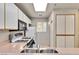 Well-lit kitchen with white cabinets, gas stove, and modern appliances under a skylight at 260 E Flamingo Rd # 311, Las Vegas, NV 89169