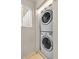 Efficient laundry room with stacked washer and dryer for space-saving convenience at 260 E Flamingo Rd # 311, Las Vegas, NV 89169