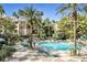 Inviting pool area with lounge chairs, palm trees, and lush landscaping at 260 E Flamingo Rd # 311, Las Vegas, NV 89169