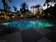 Inviting community pool area featuring a refreshing pool surrounded by swaying palm trees at dusk at 260 E Flamingo Rd # 311, Las Vegas, NV 89169