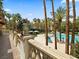 Balcony view overlooking a community pool with tropical landscaping and lounge chairs at 260 E Flamingo Rd # 311, Las Vegas, NV 89169