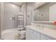 Bright bathroom features white vanity, framed mirror and tiled shower over tub at 2796 Rosenhearty Dr, Henderson, NV 89044