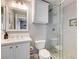 Bathroom featuring a glass shower enclosure, tiled walls, vanity with sink, and a white toilet at 2796 Rosenhearty Dr, Henderson, NV 89044