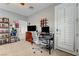 Neutral bedroom with a computer desk, guitars, and a ceiling fan at 2796 Rosenhearty Dr, Henderson, NV 89044