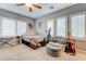 Bedroom featuring neutral walls, window shutters, carpeted floor, bed with storage, and lounge seating at 2796 Rosenhearty Dr, Henderson, NV 89044