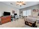 Bedroom with neutral walls, window shutters, carpeted floor, desk area, and bed with storage underneath at 2796 Rosenhearty Dr, Henderson, NV 89044