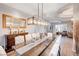 Dining room with a pendant light fixture, wood table, and view into living room at 2796 Rosenhearty Dr, Henderson, NV 89044