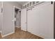 Hallway featuring modern sliding barn doors, wood floors, and neutral paint at 2796 Rosenhearty Dr, Henderson, NV 89044