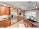 Spacious kitchen with wood cabinets, granite counters, an island, and stainless steel appliances at 2796 Rosenhearty Dr, Henderson, NV 89044