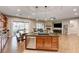 Open floor plan showcasing an island kitchen with dining table, stainless steel appliances, and granite counters at 2796 Rosenhearty Dr, Henderson, NV 89044