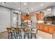 Kitchen featuring wood cabinets, granite counters, stainless appliances, and a central island with seating at 2796 Rosenhearty Dr, Henderson, NV 89044