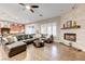 Cozy living room with a fireplace, hardwood floors, and access to the adjacent kitchen at 2796 Rosenhearty Dr, Henderson, NV 89044