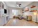 Cozy living room with hardwood floors, comfortable seating, and natural light from large windows at 2796 Rosenhearty Dr, Henderson, NV 89044