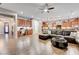 Open-concept living room and kitchen area with a desk nook, hardwood floors and modern furnishings at 2796 Rosenhearty Dr, Henderson, NV 89044