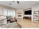 Well-lit living room with a stone fireplace, comfortable sectional sofa, and large windows at 2796 Rosenhearty Dr, Henderson, NV 89044