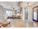 Inviting living room featuring a tray ceiling, hardwood floors, and an open staircase at 2796 Rosenhearty Dr, Henderson, NV 89044