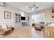 Cozy living room featuring a ceiling fan, plantation shutters, and built-in display cabinets at 2796 Rosenhearty Dr, Henderson, NV 89044