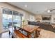 Bright living room with a large sectional sofa, fireplace, and sliding glass doors to the outdoor space at 2796 Rosenhearty Dr, Henderson, NV 89044