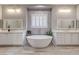 Spa-like main bathroom featuring a soaking tub, dual vanities, and stylish fixtures at 2796 Rosenhearty Dr, Henderson, NV 89044