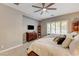 Bright main bedroom featuring a ceiling fan, window with shutters, and a TV at 2796 Rosenhearty Dr, Henderson, NV 89044