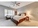 Serene main bedroom with plush carpeting, a ceiling fan, and a cozy sitting area at 2796 Rosenhearty Dr, Henderson, NV 89044