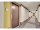 Clean condo hallway with modern carpeting, warm lighting, and unit door 205 at 29 Montelago Blvd # 205, Henderson, NV 89011