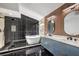 Modern bathroom featuring a soaking tub, glass-enclosed shower, and double sink vanity at 2921 Moonlight Bay Ln, Las Vegas, NV 89128