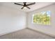 Bedroom featuring a large window with natural light and a ceiling fan at 2921 Moonlight Bay Ln, Las Vegas, NV 89128