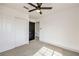 Comfortable bedroom with a ceiling fan and closet with sliding doors and a black interior door at 2921 Moonlight Bay Ln, Las Vegas, NV 89128