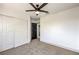 Bedroom with ceiling fan, closet and a black interior door leading to other areas of the home at 2921 Moonlight Bay Ln, Las Vegas, NV 89128