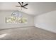 Large primary bedroom with new carpet and large window providing lots of natural light at 2921 Moonlight Bay Ln, Las Vegas, NV 89128