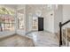 Bright foyer with marble floors, a staircase, and clerestory windows at 2921 Moonlight Bay Ln, Las Vegas, NV 89128